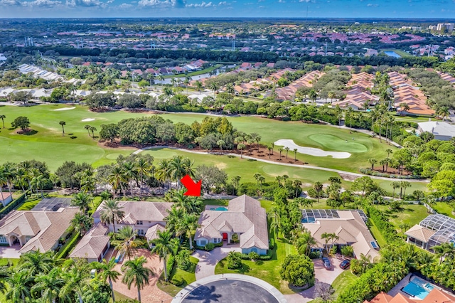 birds eye view of property featuring view of golf course and a residential view