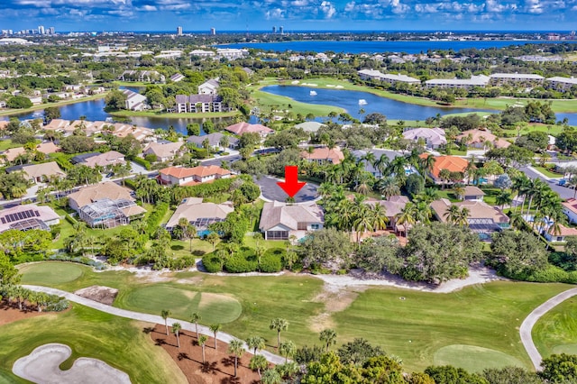aerial view featuring a residential view, golf course view, and a water view