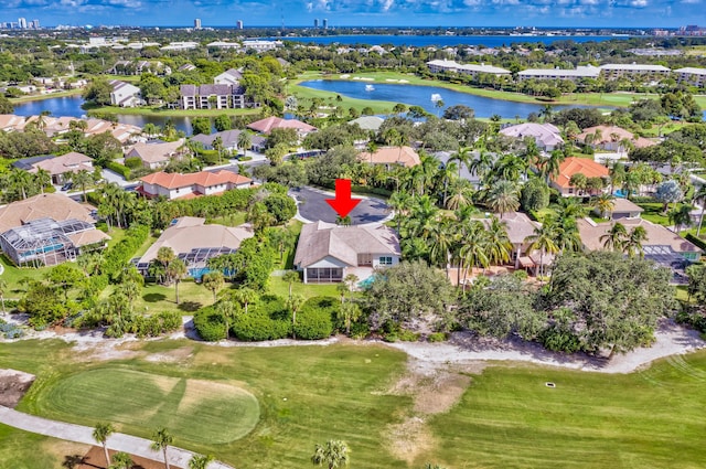 birds eye view of property with a water view, a residential view, and view of golf course