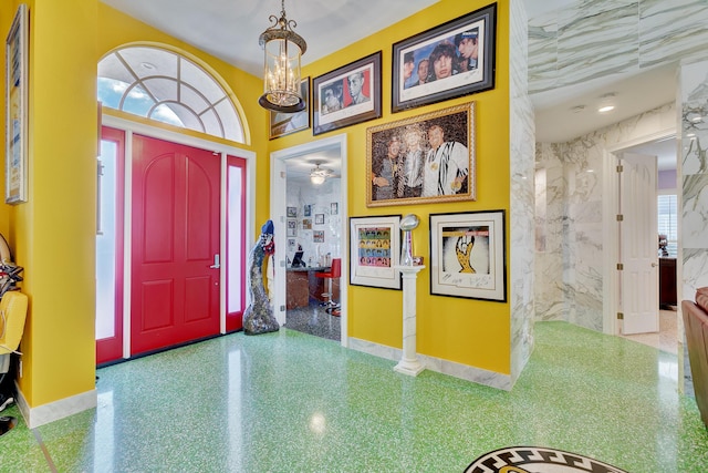 entrance foyer featuring baseboards and a notable chandelier