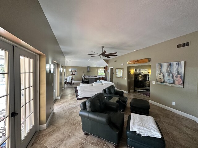 living area featuring a ceiling fan, baseboards, and visible vents