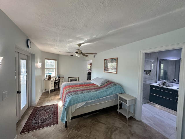 tiled bedroom with a ceiling fan and a textured ceiling