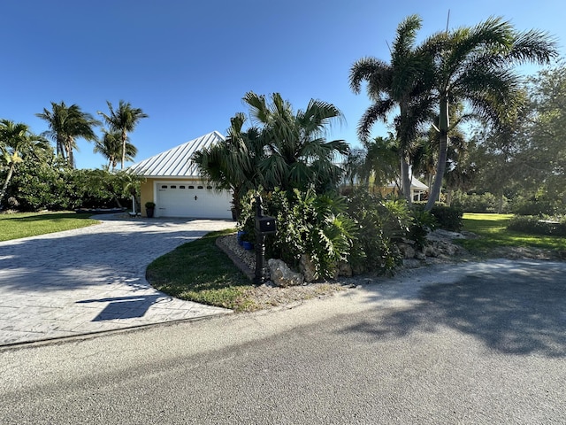 obstructed view of property with an attached garage and driveway