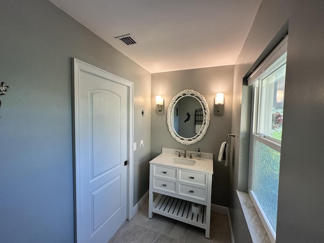bathroom featuring baseboards, visible vents, and vanity