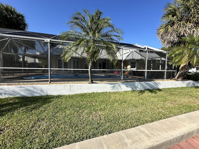 view of property's community featuring a yard and a swimming pool