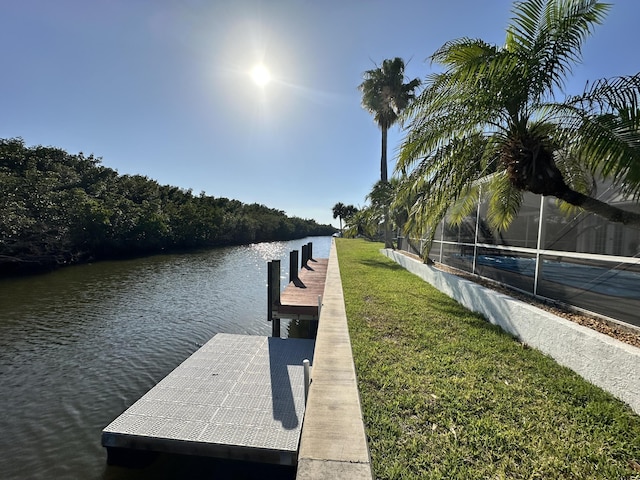 dock area featuring a water view and a yard