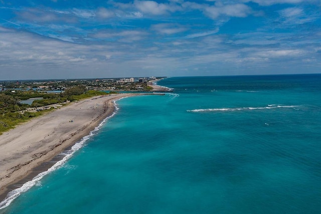 drone / aerial view with a beach view and a water view