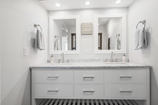 bathroom with a sink and double vanity