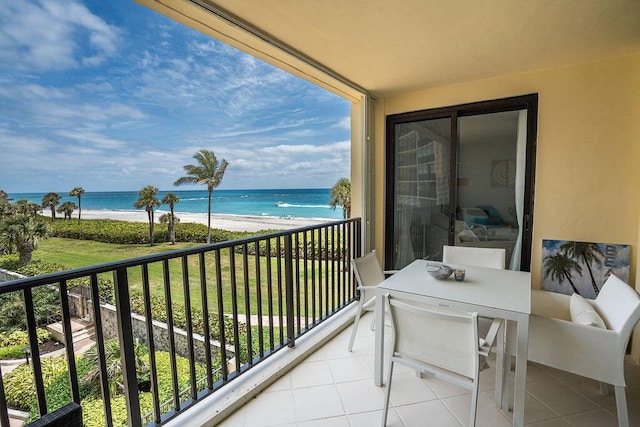 balcony with a beach view and a water view