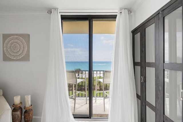 doorway to outside with a water view and crown molding