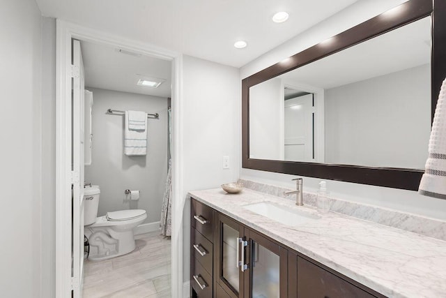 full bath with recessed lighting, toilet, vanity, and baseboards