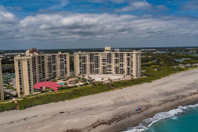 birds eye view of property with a beach view and a water view