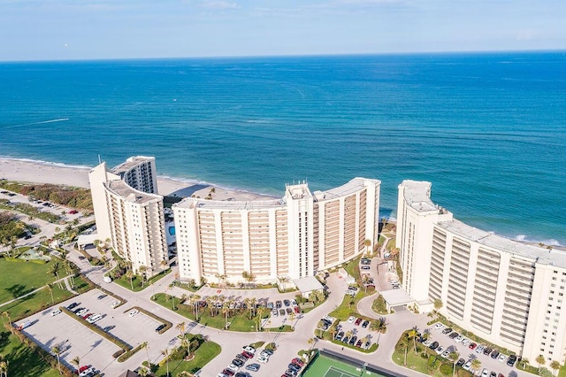 birds eye view of property featuring a beach view and a water view