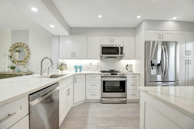 5749 Gemstone Ct Unit 404, Boynton Beach, FL 33437 - kitchen with appliances with stainless steel finishes, light stone countertops, a sink, and recessed lighting