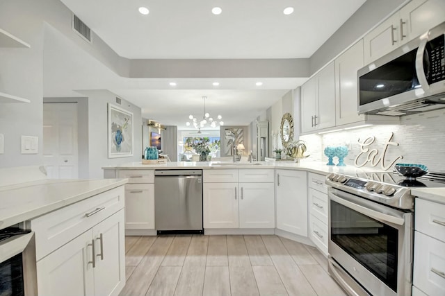 5749 Gemstone Ct Unit 404, Boynton Beach, FL 33437 - kitchen featuring appliances with stainless steel finishes, light countertops, a notable chandelier, visible vents, and recessed lighting