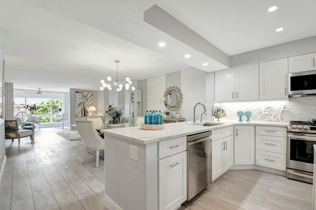 5749 Gemstone Ct Unit 404, Boynton Beach, FL 33437 - kitchen featuring recessed lighting, a peninsula, appliances with stainless steel finishes, and a sink