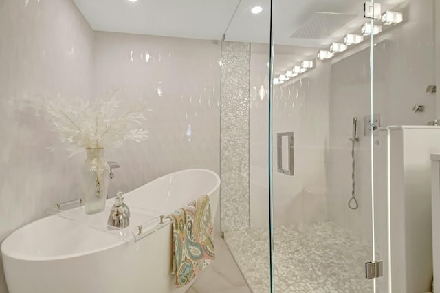 5749 Gemstone Ct Unit 404, Boynton Beach, FL 33437 - bathroom featuring a freestanding bath, recessed lighting, and a stall shower