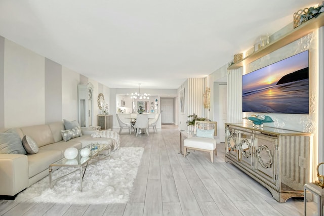 5749 Gemstone Ct Unit 404, Boynton Beach, FL 33437 - living room featuring light wood-type flooring and a notable chandelier