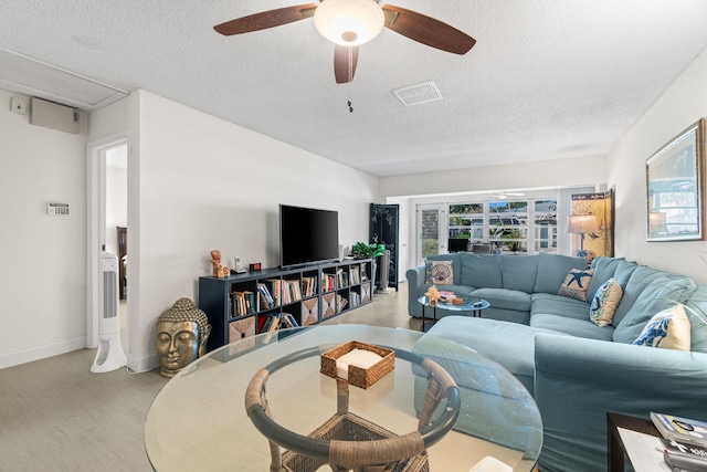 13756 Via Flora Unit A, Delray Beach, FL 33484 - living area with a textured ceiling, visible vents, a ceiling fan, and baseboards