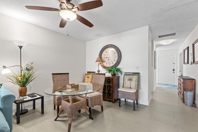 13756 Via Flora Unit A, Delray Beach, FL 33484 - dining area featuring ceiling fan, baseboards, a textured ceiling, and visible vents