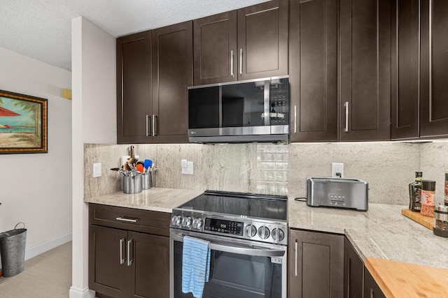 13756 Via Flora Unit A, Delray Beach, FL 33484 - kitchen with appliances with stainless steel finishes, dark brown cabinets, and light countertops