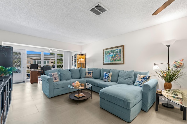 13756 Via Flora Unit A, Delray Beach, FL 33484 - living area featuring a ceiling fan, visible vents, and a textured ceiling