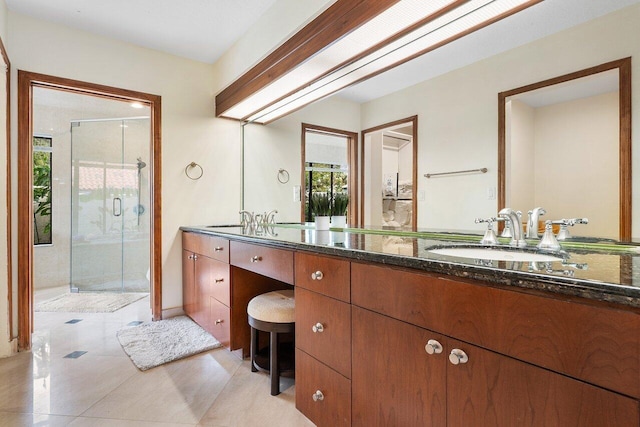 full bathroom with tile patterned floors, a shower stall, and vanity