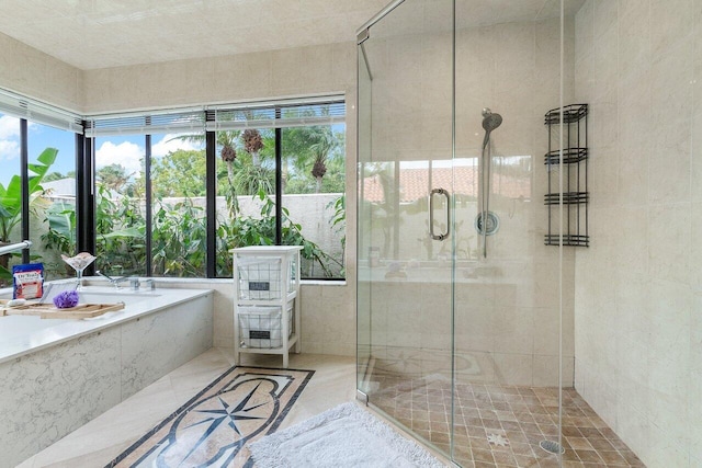 full bath with tile patterned floors, a stall shower, and a garden tub