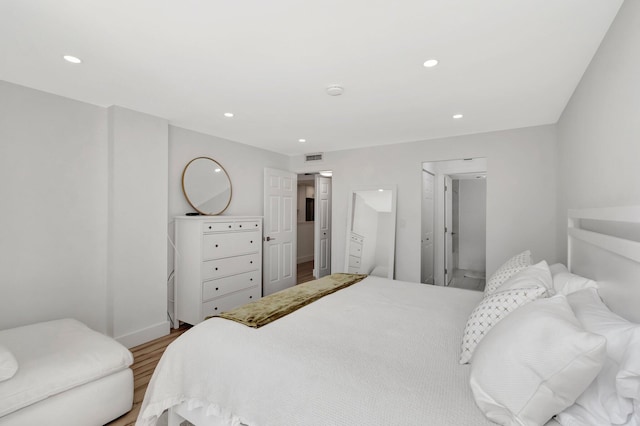 bedroom featuring recessed lighting, wood finished floors, and visible vents