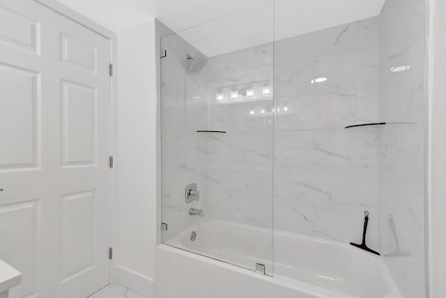 full bathroom with marble finish floor, baseboards, and bathtub / shower combination