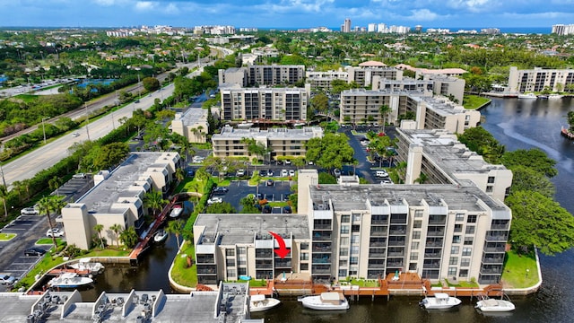 birds eye view of property with a city view and a water view