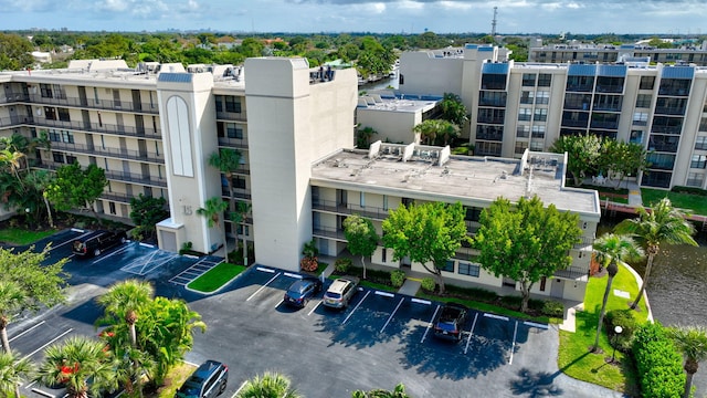 view of building exterior with uncovered parking