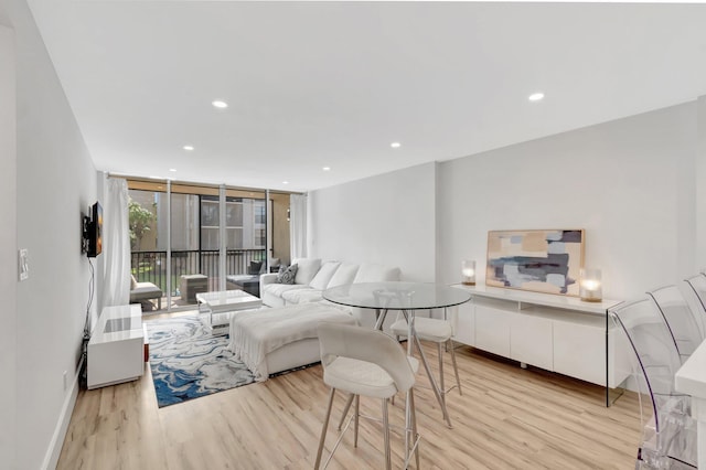 living room featuring light wood finished floors and recessed lighting