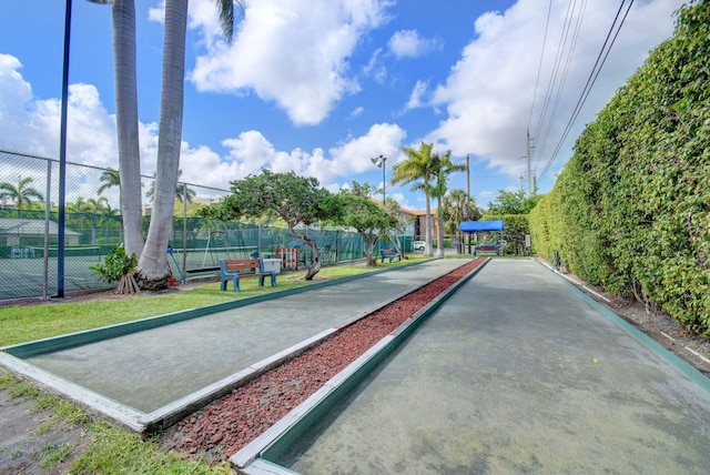 view of home's community featuring fence