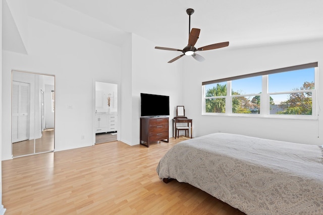 bedroom featuring light wood finished floors, a ceiling fan, and high vaulted ceiling