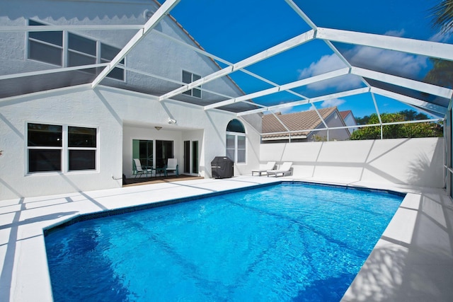 view of pool featuring a fenced in pool, area for grilling, a patio, and a lanai