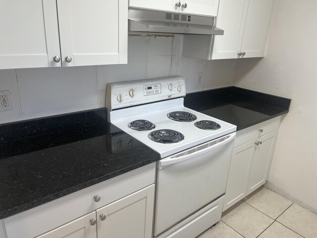 1626 Meadows Cir W Unit 1626, Boynton Beach, FL 33436 - kitchen with dark stone counters, white cabinetry, under cabinet range hood, white range with electric stovetop, and light tile patterned floors