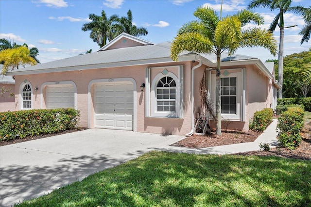 ranch-style home with stucco siding, concrete driveway, and a garage