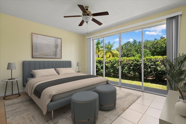 bedroom with tile patterned flooring, access to exterior, and ceiling fan