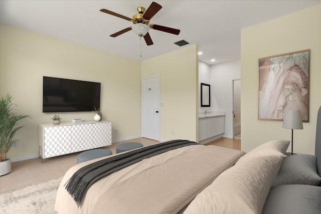 tiled bedroom with recessed lighting, ceiling fan, ensuite bath, visible vents, and baseboards