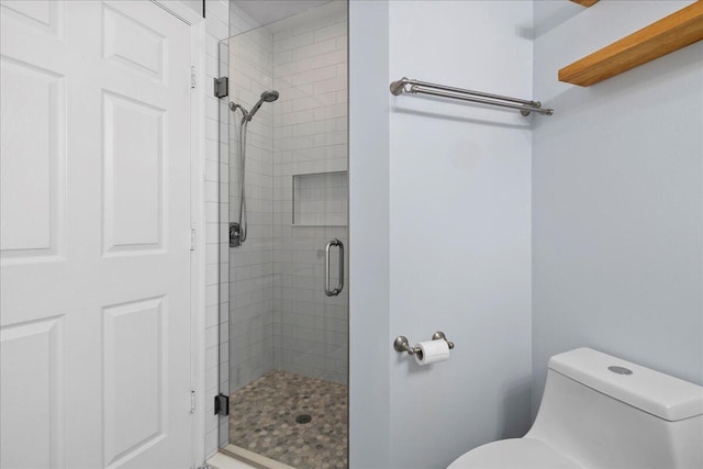 full bathroom with a stall shower and toilet