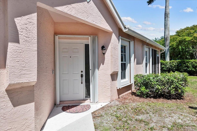 property entrance featuring stucco siding