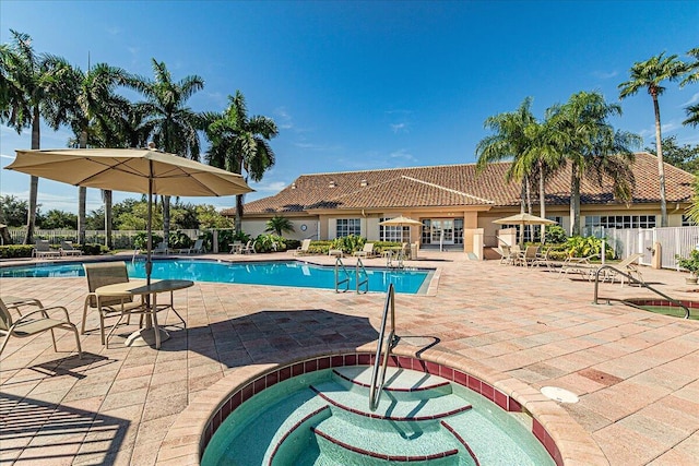 pool featuring fence and a patio area