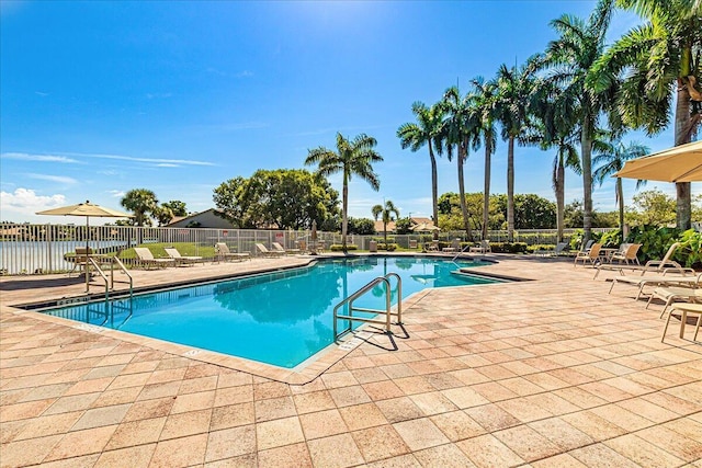 pool featuring fence and a patio