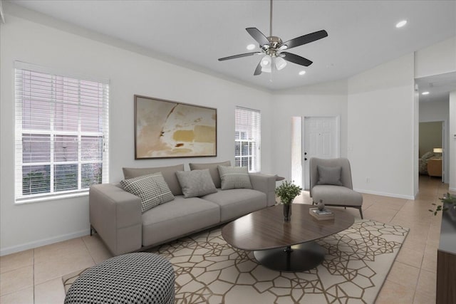 living area with light tile patterned flooring, a wealth of natural light, and baseboards