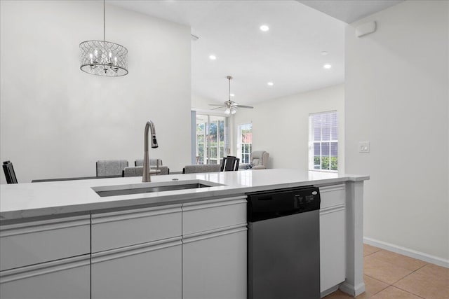 kitchen featuring white cabinets, stainless steel dishwasher, light countertops, and a sink