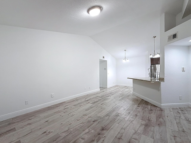 595 Vista Isles Dr Unit 1926, Sunrise, FL 33325 - unfurnished living room with light wood finished floors, lofted ceiling, a chandelier, baseboards, and a textured ceiling