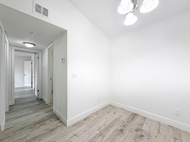 595 Vista Isles Dr Unit 1926, Sunrise, FL 33325 - empty room featuring a chandelier, light wood-style flooring, and baseboards