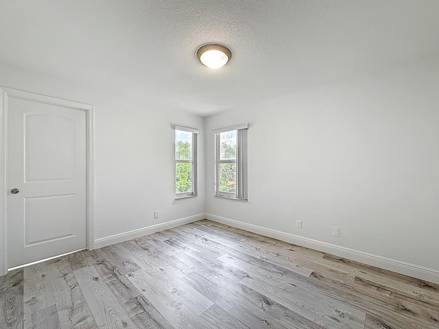 595 Vista Isles Dr Unit 1926, Sunrise, FL 33325 - empty room featuring light wood-type flooring, baseboards, and a textured ceiling