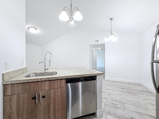 595 Vista Isles Dr Unit 1926, Sunrise, FL 33325 - kitchen with stainless steel appliances, a sink, a chandelier, a peninsula, and vaulted ceiling